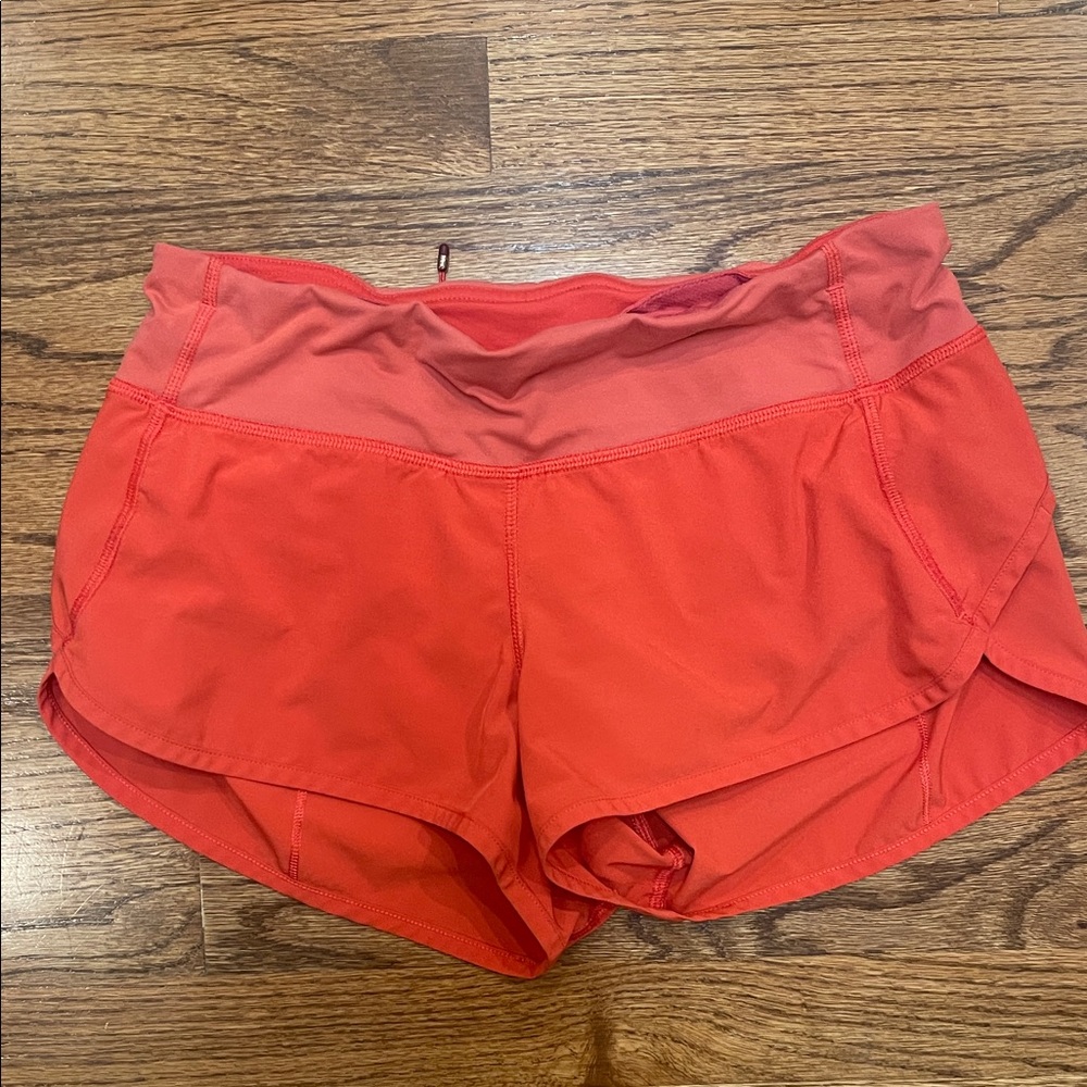 Coral Lululemon ladies speed up shorts, size 4